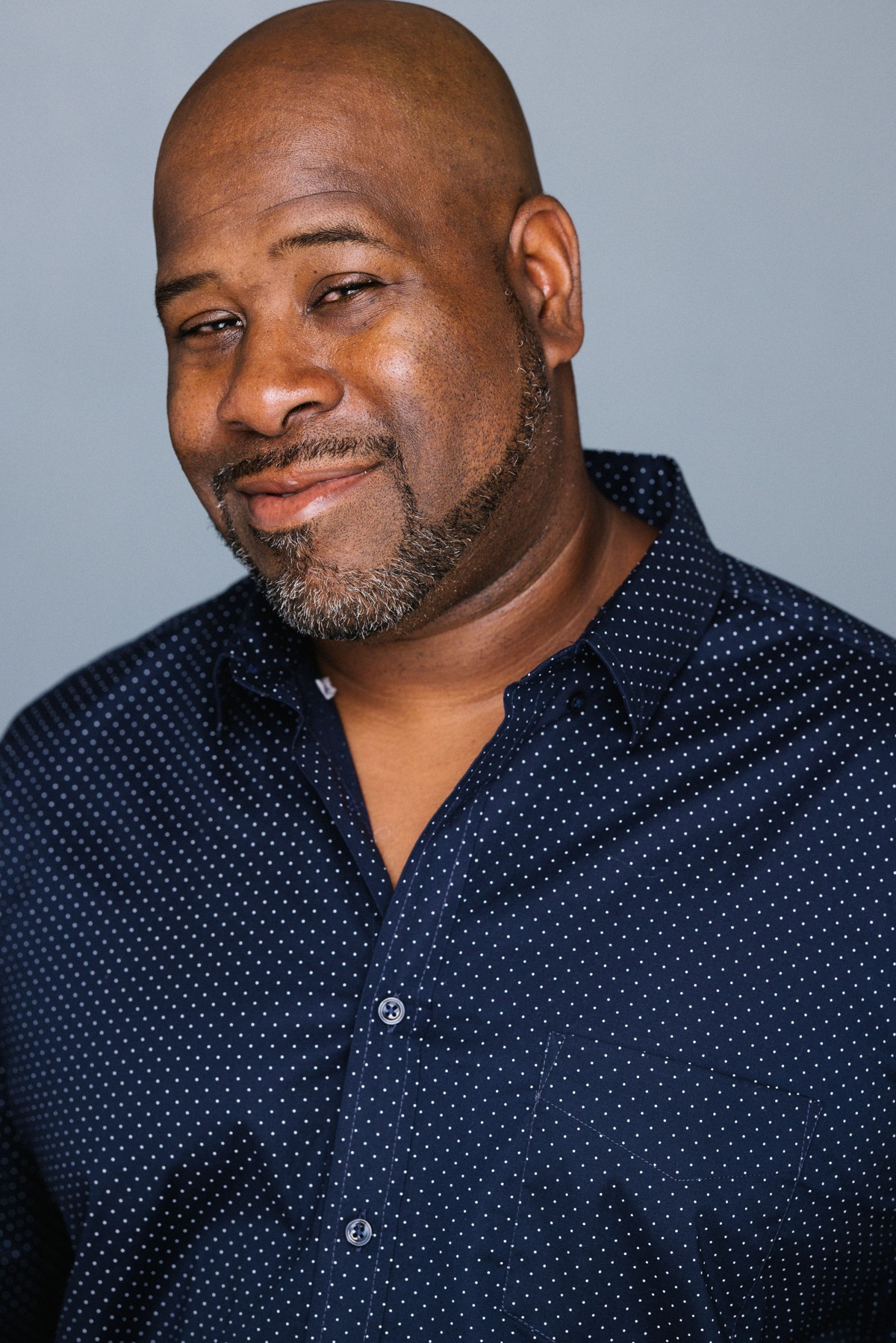 Portrait of Talj B Howard in a navy patterned shirt